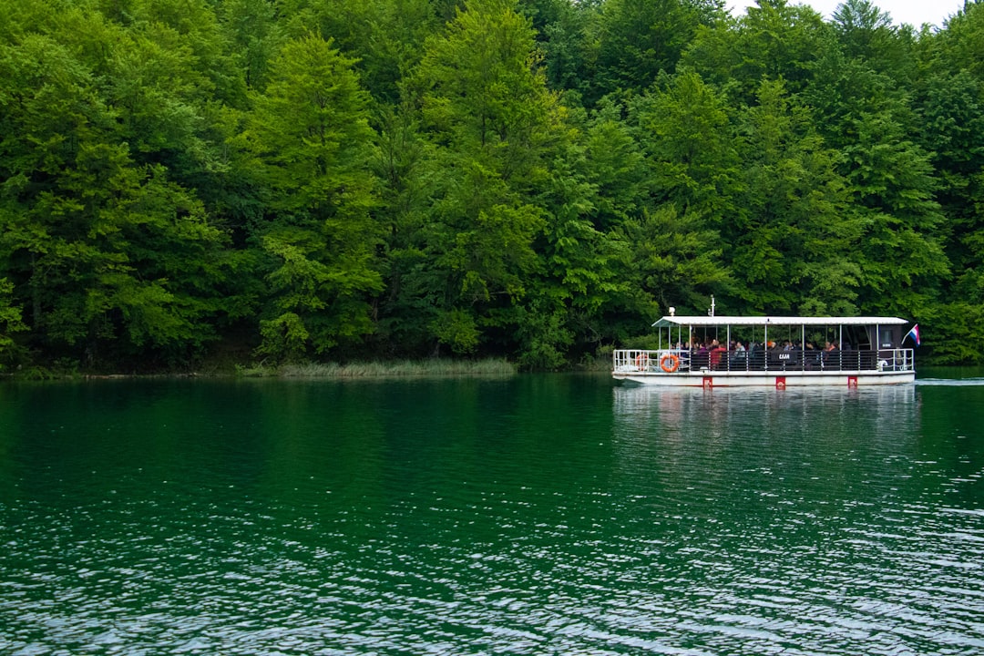 Electric boat crossing turquoise Kozjak lake at Plitvice