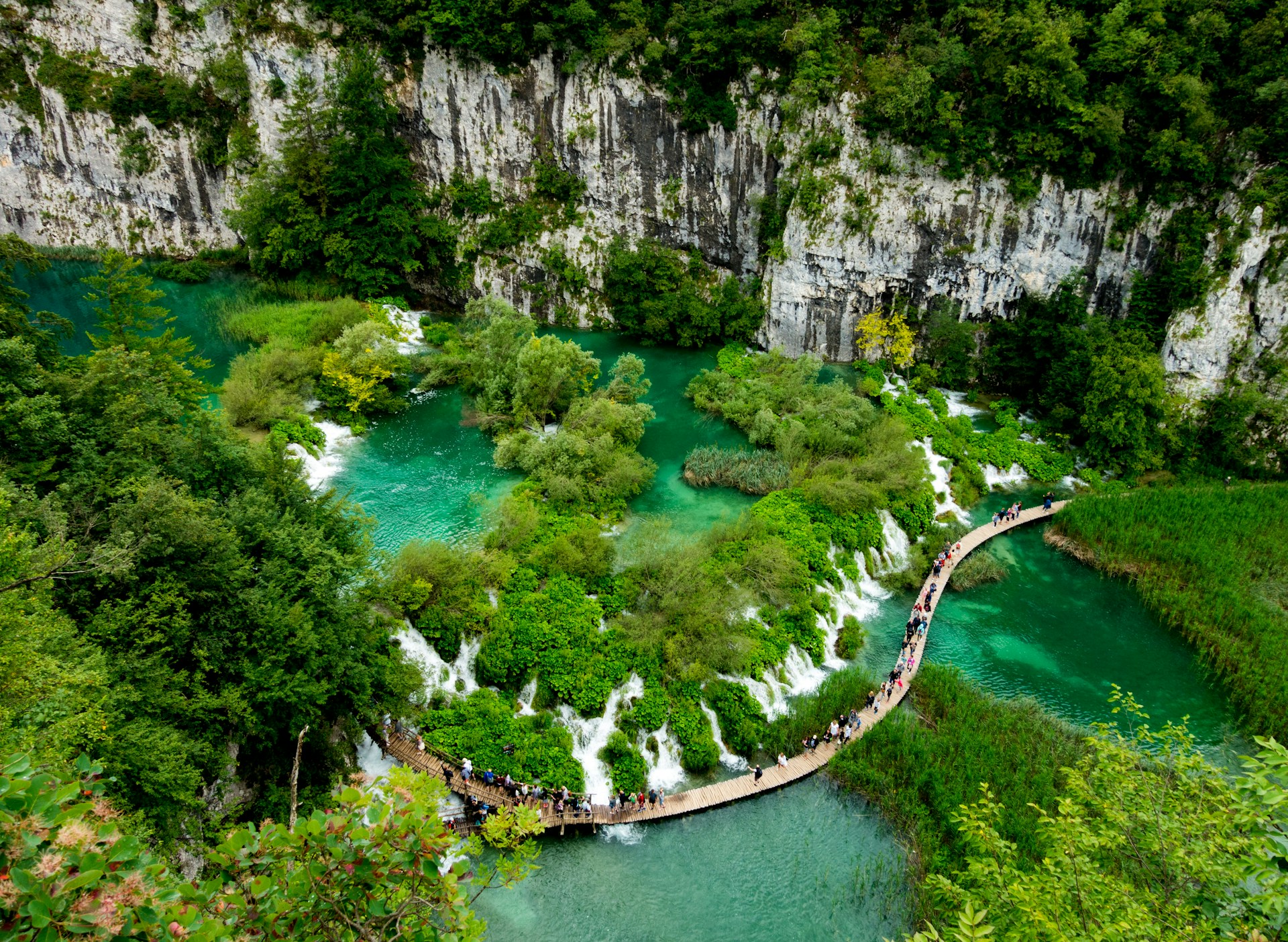 Wooden boardwalk trail winding through Plitvice Lakes National Park