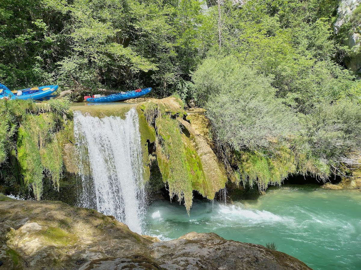 Kayaking on river canyon through forested landscape